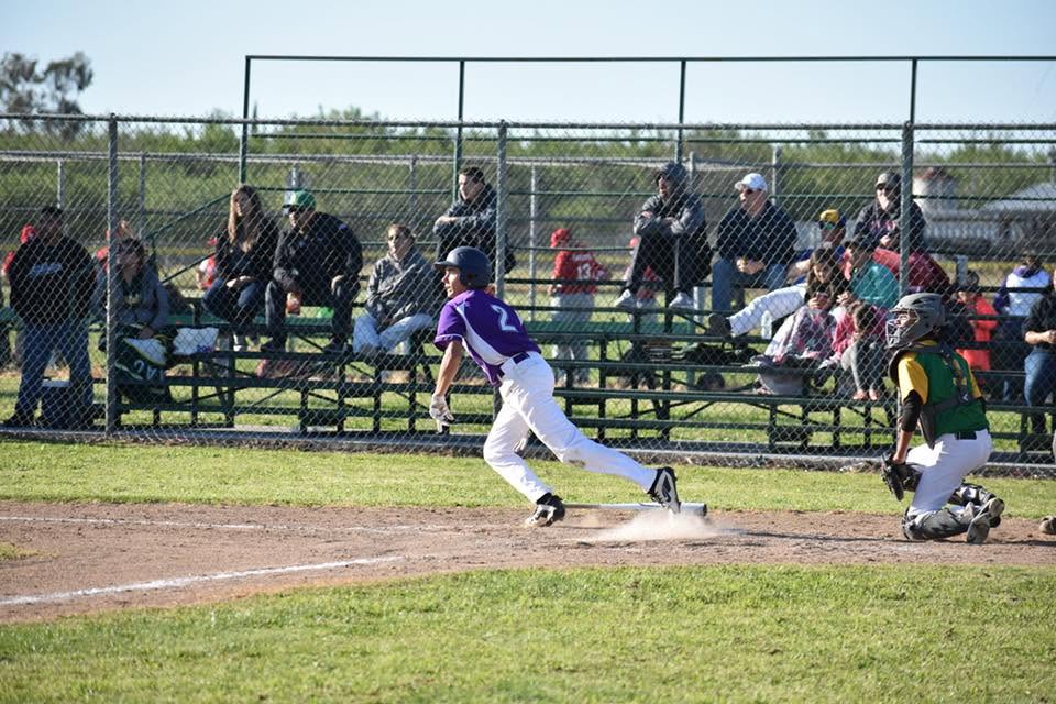 student playing baseball